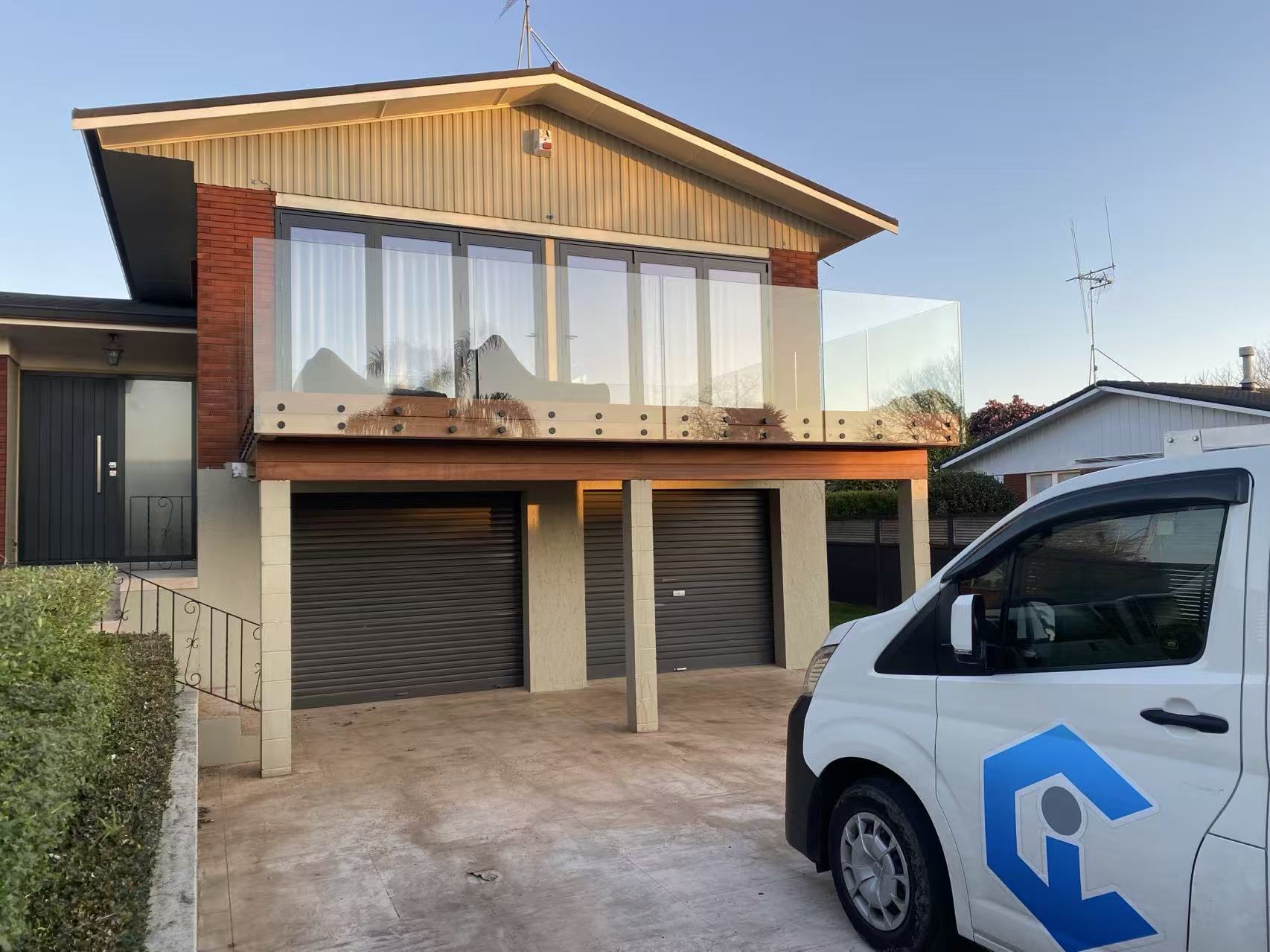 Clear glass balcony added to an existing two-storey home