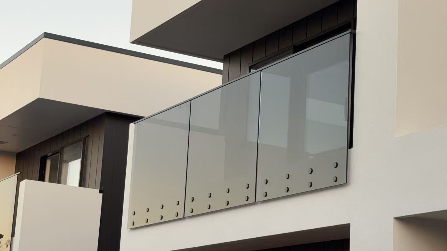 Side-fixed glass balcony panels on a contemporary home